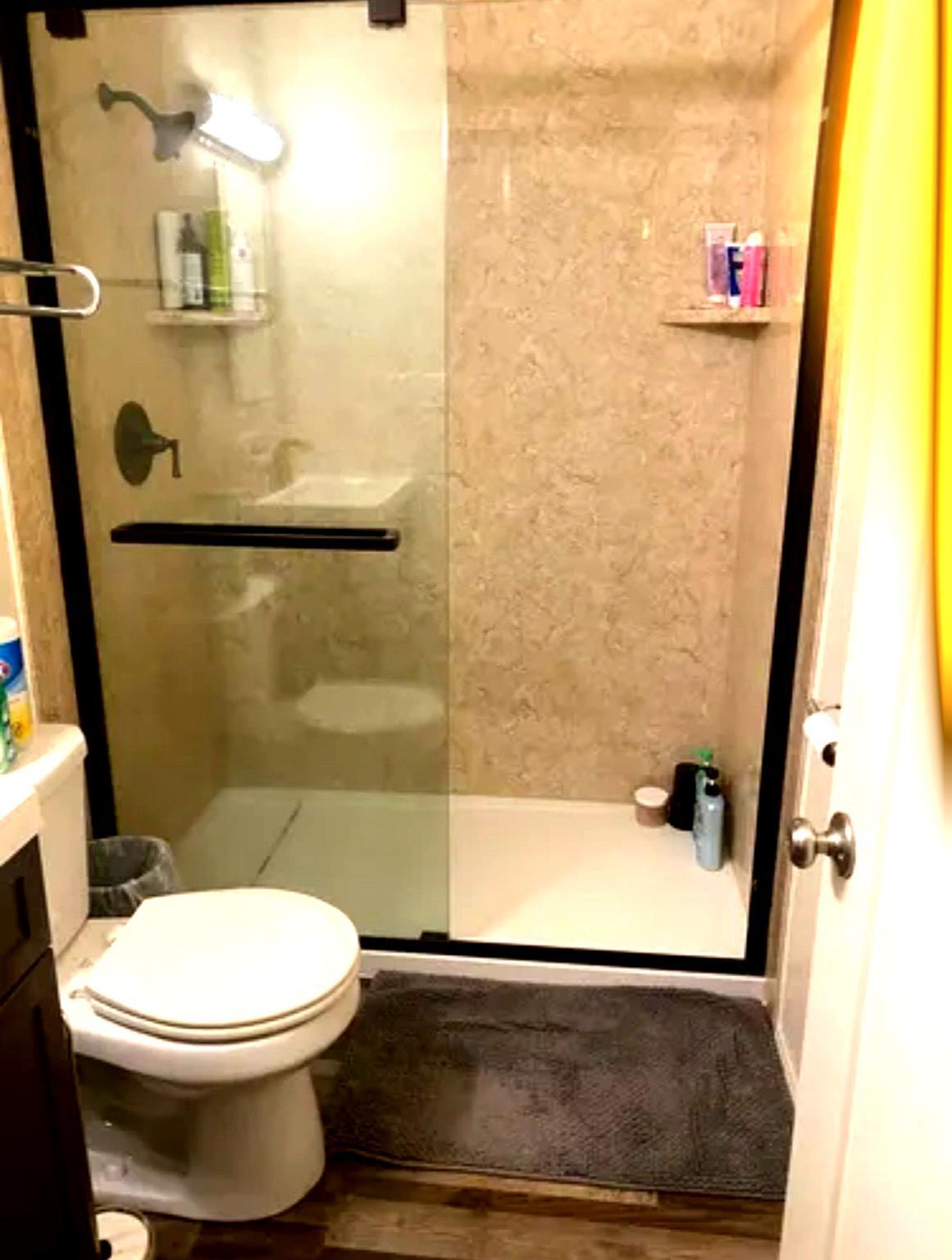Reflection in Shower Door shows Vanity with updated lights - 506 122nd St S