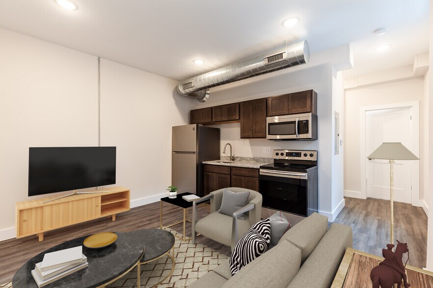 Great room complete with Vinyl Plank flooring, high ceilings, wood cabinetry and stainless appliance - 722 E McMillan St