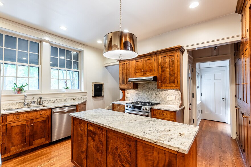 Kitchen has back stairs to 2nd & 3rd floors. - 4061 Beechwood Ave