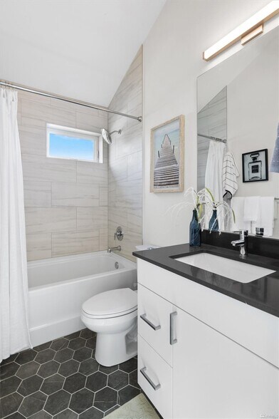Full bath with tiled shower and quartz countertop serves both bedrooms upstairs - 2117 S Walker St