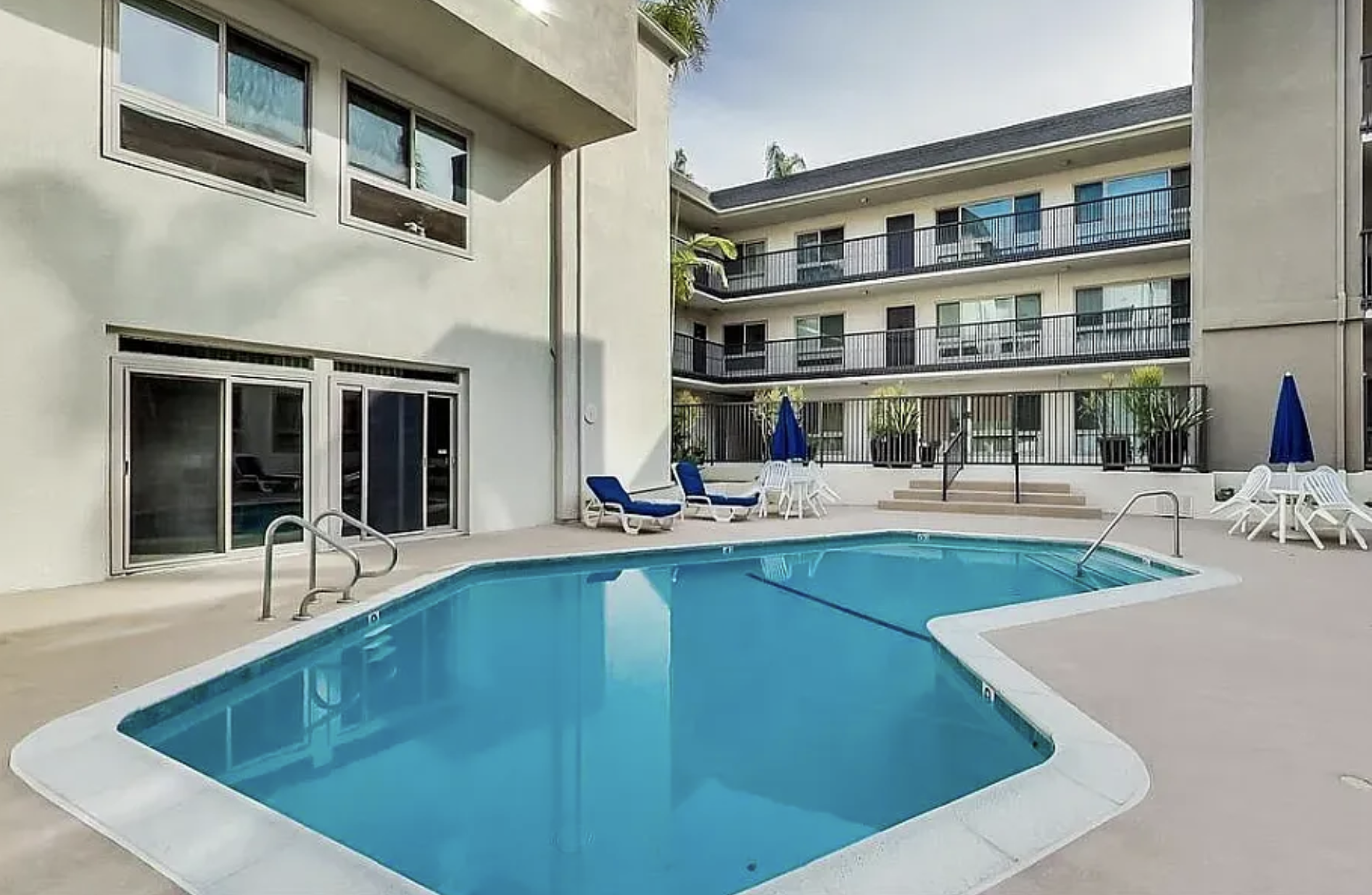Pool view from the pool deck. Rec room is on the left side. - 6001 Canterbury Dr