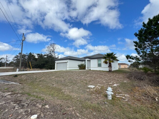 Building Photo - Spacious 4-Bedroom Home in Poinciana – Internet Included & No HOA Approval Required