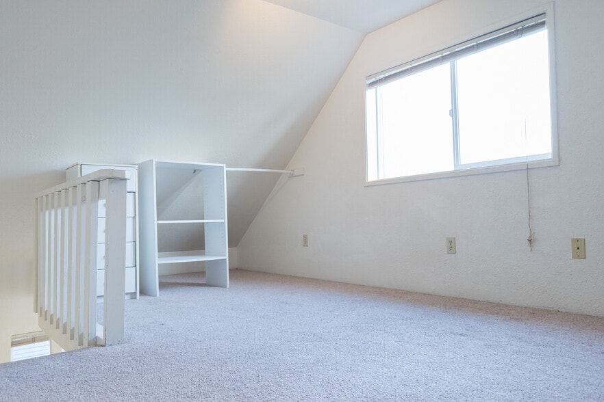 Bedroom area (loft style), stairs to left of photo. Nice large window! - 1007 W Main St
