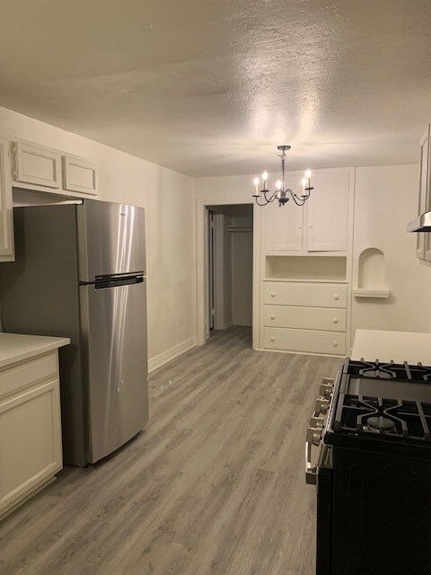 View of the dining room and built-in cabinets from the front door. - 24606 University Ave