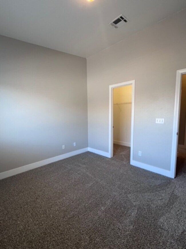 Building Photo - Three bedroom townhouse with 2 car garage