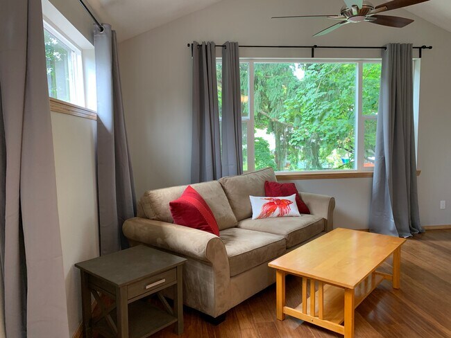 Living Room with large front window and trees right outside. - 6122 SE 45th Ave.