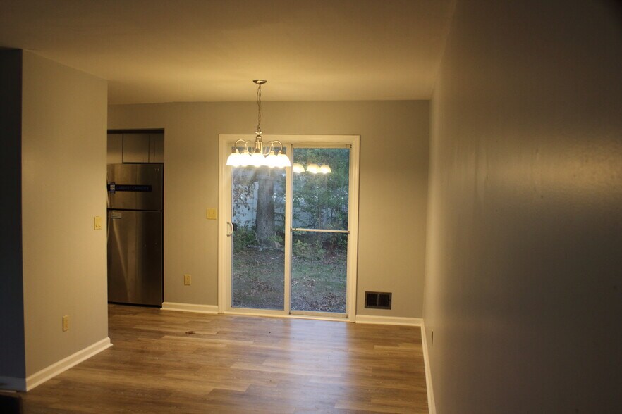 Open concept living room looking into dining area - 573 Innkeeper Ln
