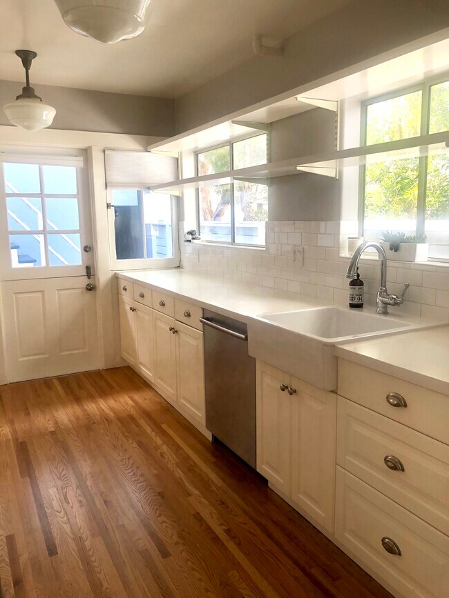 Spacious updated kitchen, quartz countertops, open shelving. - 232 Market St