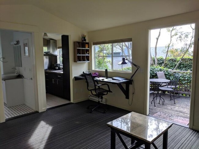 Built-in table space, view into kitchen and deck from main room. - 1515 Valley Rd