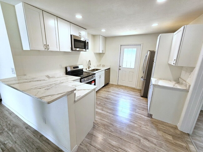 Building Photo - fully renovated 2-bedroom, 1-bathroom home with bonus guest room or office and oversized fenced yard