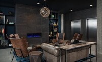 Stylish Resident Lounge with Leather Seating and Modern Fireplace at Pike Motorworks - Pike Motorworks