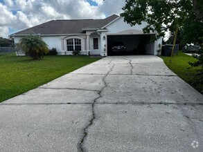 Building Photo - Three-Bedroom House with a Fenced Yard!