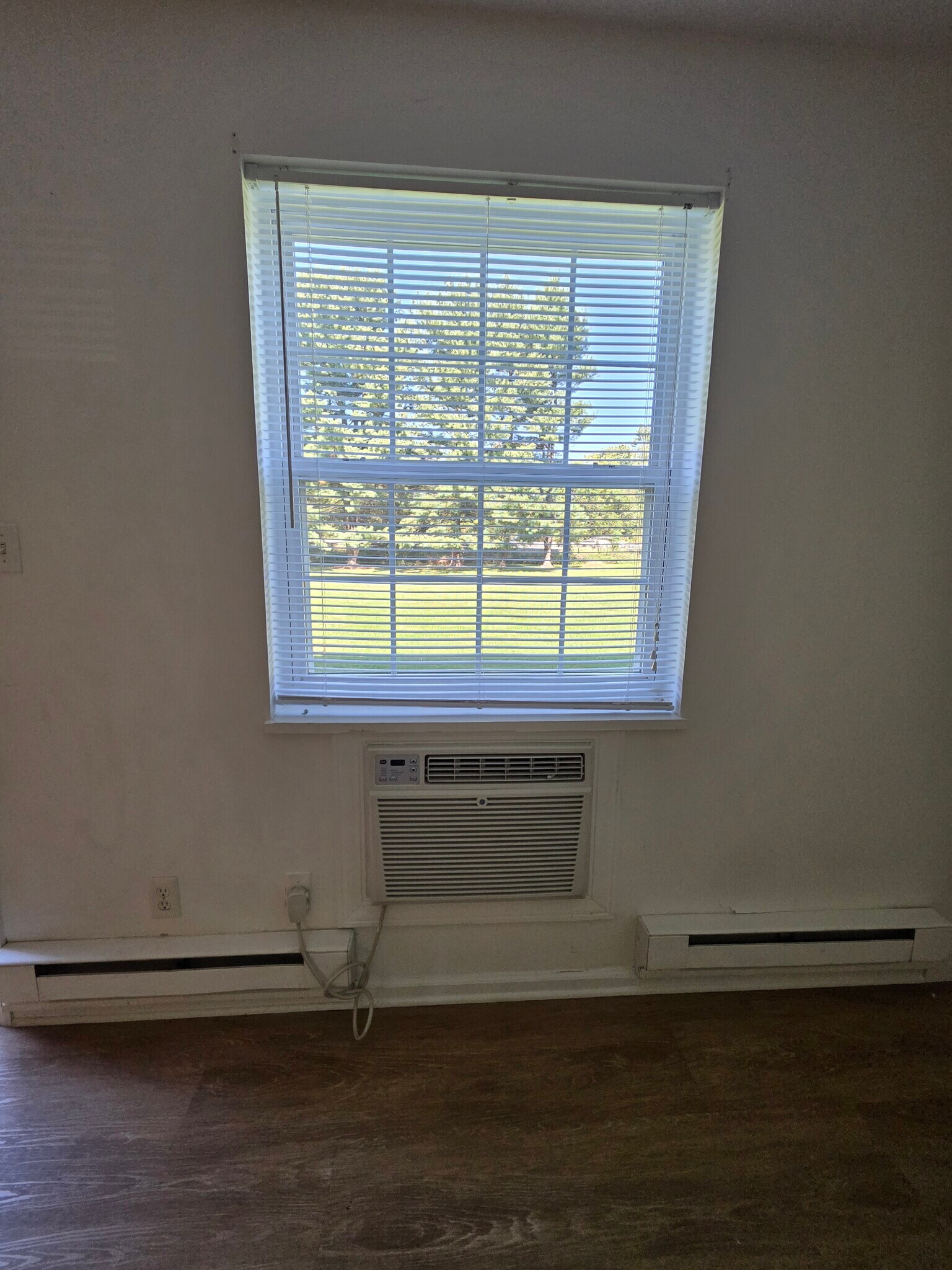 A/C unit in living room area. Will cool entire unit. - 152 Church St