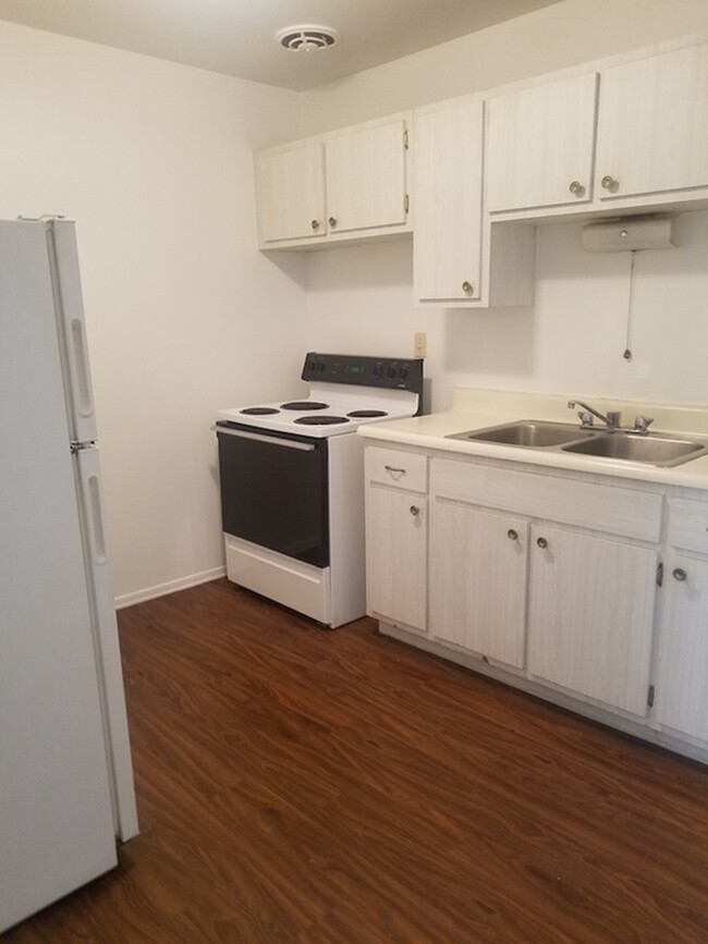 Step into this cozy kitchen featuring functional design and a welcoming atmosphere. - Beecher Street