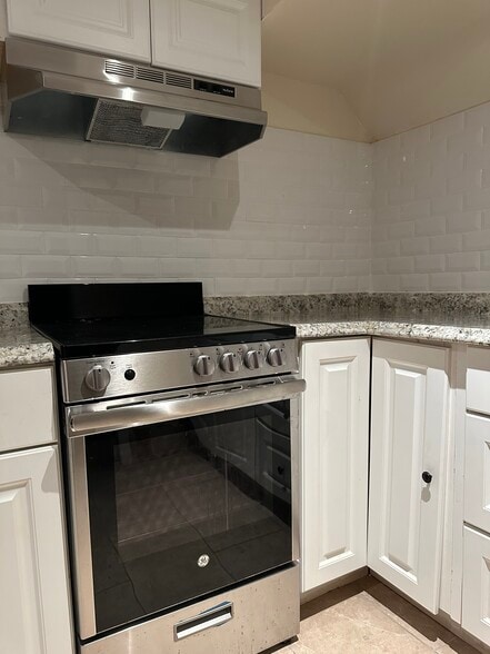 Stainless steel stove with hood - 62 E Centennial Ave