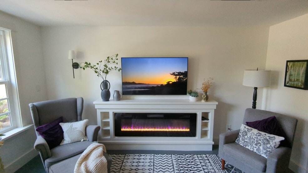 Living room with fireplace and TV and garden view - 1411 NW 120th St