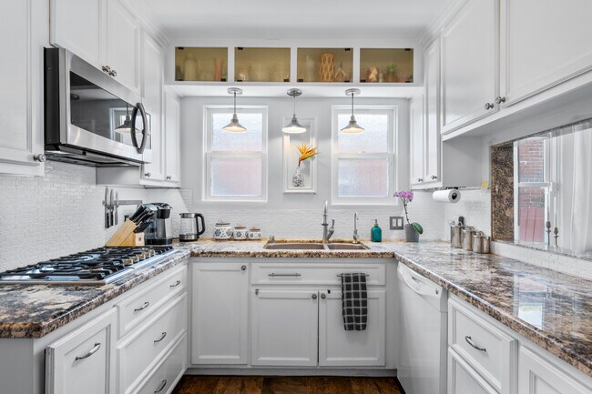 Upgraded kitchen with stainless steel appliances. - 1150 W 25th St