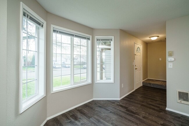 Building Photo - Recently Updated with Wood Laminate Flooring and Fresh Paint