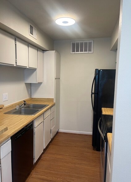 Kitchen with Bosch dishwasher. Upgraded kitchen faucet being installed. - 4441 Old College Rd