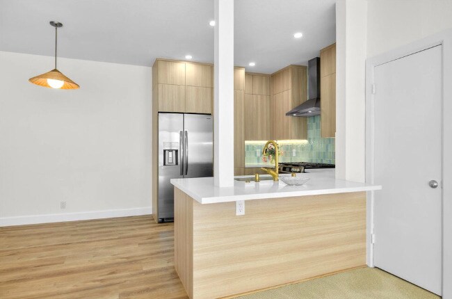 Enjoy drinks at the quartz counter while chatting with the cook. - 2221 Ocean Ave