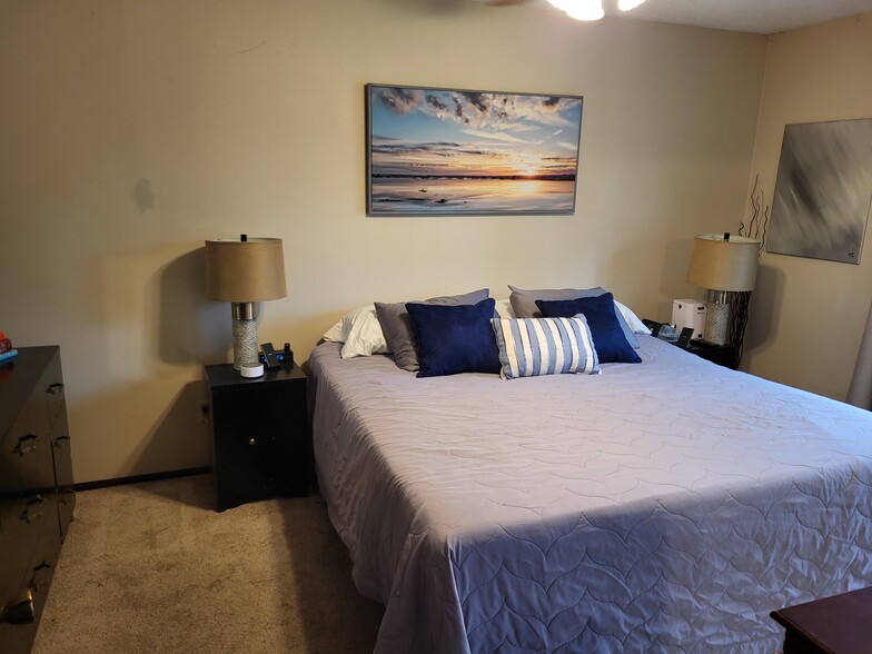 Upper level large primary bedroom, will be freshly painted and new carpet will be installed - 8460 Red Oak Dr