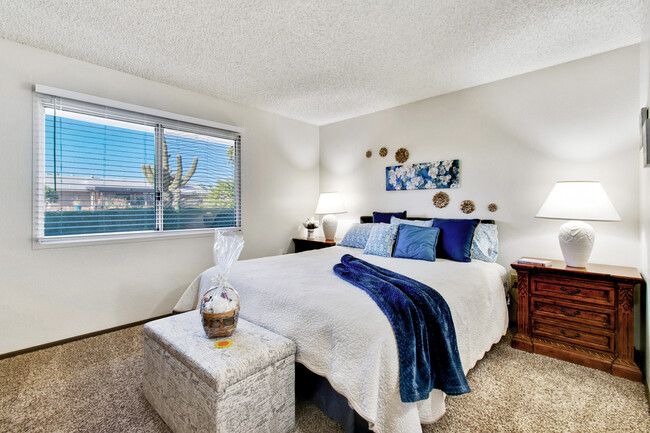 Master bedroom offers a king size bed and nightstands with lots of storage. - 12414 W Nugget Ct