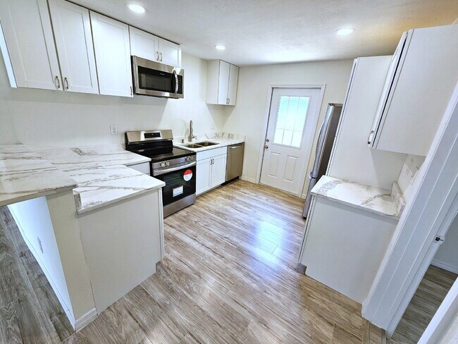 Building Photo - fully renovated 2-bedroom, 1-bathroom home with bonus guest room or office and oversized fenced yard