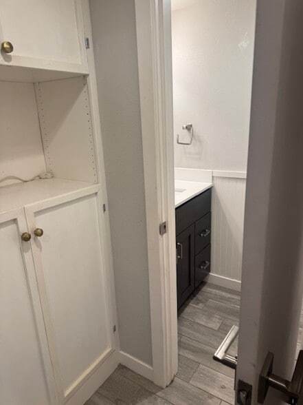 downstairs half bath and extra storage built in cabinet - 15955 Mauna Ct