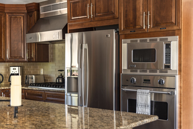 With a spacious island that seats four, this kitchen is perfect for cooking together. - 71535 Biskra Rd