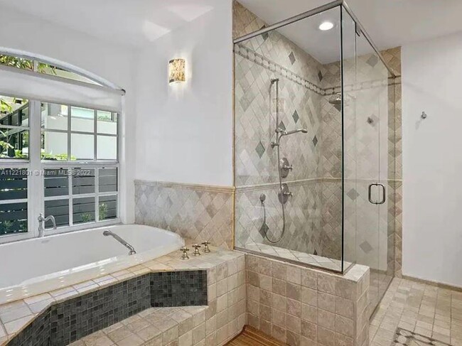 Primary bath with soaking tub & separate shower & frameless shower door - 1109 NE 3rd St