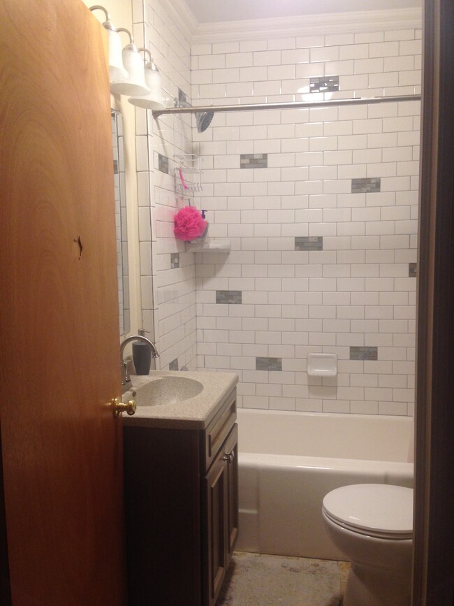 Tiled shower Bath has updated vanity and linen closet - 2913 S Rogers St