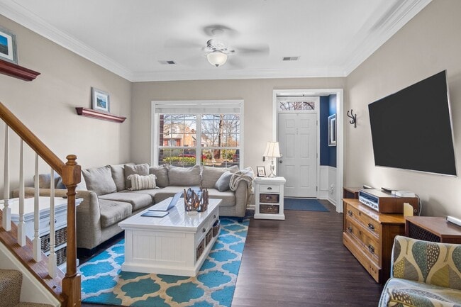 Building Photo - This inviting two-level townhome offers comfort and style, featuring gleaming hardwood floors on ...