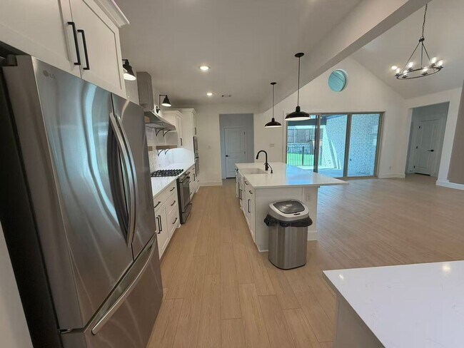 Building Photo - Move-in ready and like-new! Washer, dryer, and refrigerator Included.