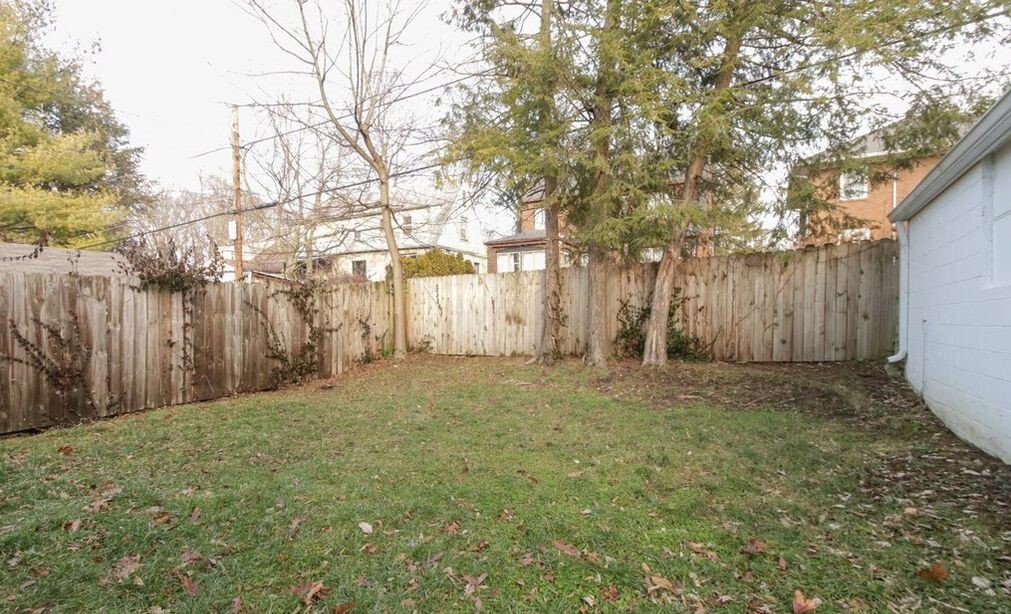 Fenced backyard next to patio. - 5101 Boulevard Pl