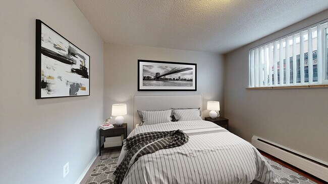 Experience tranquility in this beautifully designed bedroom, perfect for restful nights. - Harmony Apartments