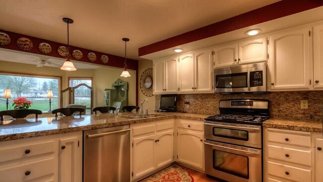 Building Photo - 4bd/3ba HUGE Home w/Hardwood Floors, Russian Fireplace, 2-Car Garage & Fenced Back Yard!