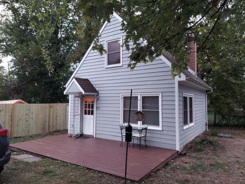 Exterior - small table and 2 chairs on deck, covered entry, exterior light - 311 Newton Aly