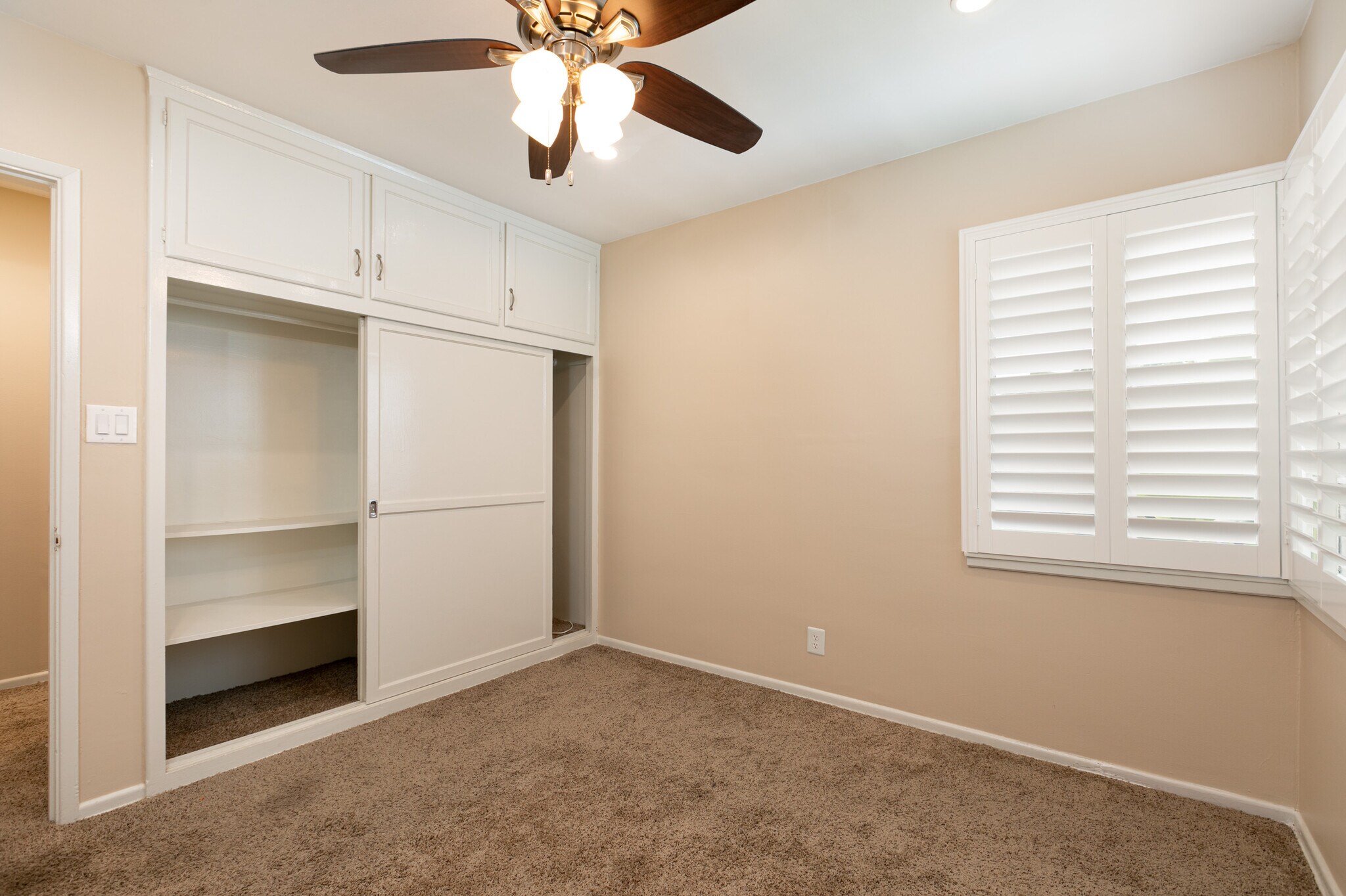 bedroom with plantation shutters - 1317 19th St
