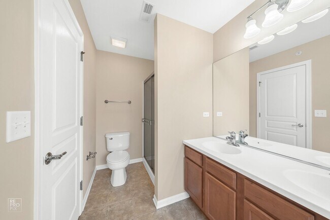 Building Photo - AUTUMN CREEK SECOND FLOOR CONDO WITH TWO CAR GARAGE