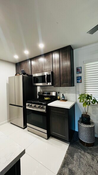 New kitchen with stainless steel refrigerator, dishwasher, stove with built-in air fryer, microwave - 6600 Warner Ave