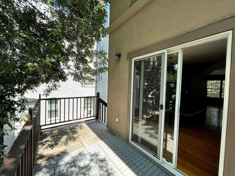 Balcony that faces the courtyard. Easily fits a sectional sofa and tables. - 1641 N Washington St