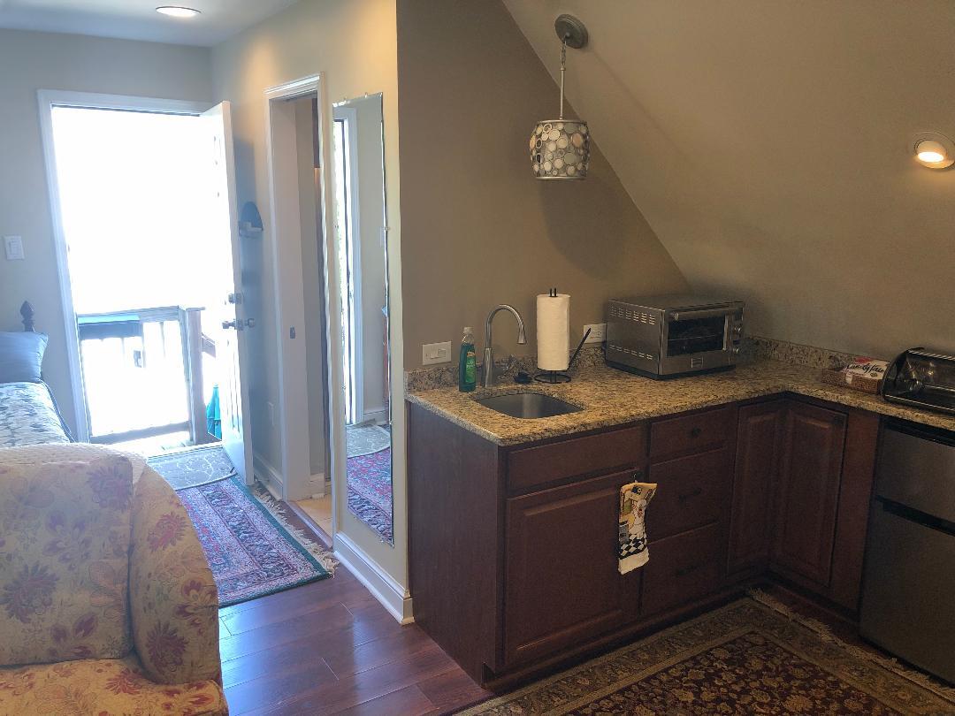 Granite counters, wall mirror and cabinets for storage. - 5804 Searl Ter