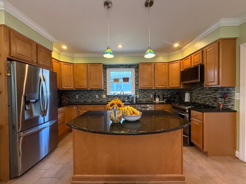 Kitchen with new stainless steel fridge, microwave, and Bosch dishwasher. Gas stove. - 5715 7th St N