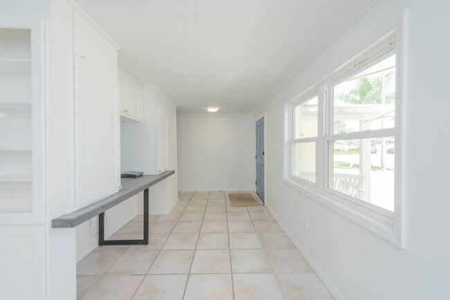 Building Photo - Live the ultimate Space Coast waterfront lifestyle at this stunning beachside canal home in Satel...