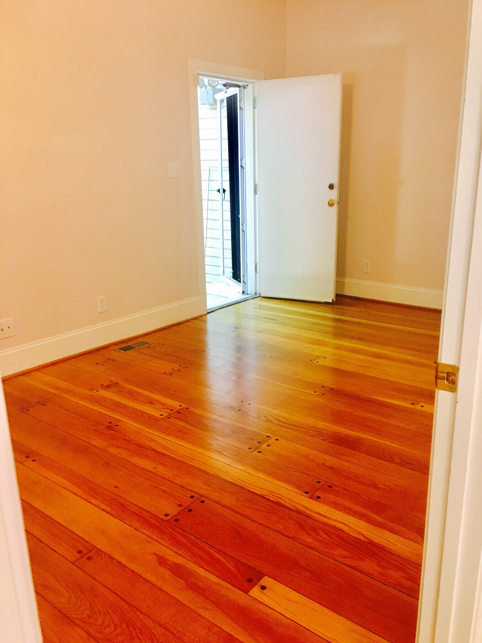 Bedroom with hardwood floors, high ceilings, and calm, sunlit comfort. - 1937 Fairfield Dr