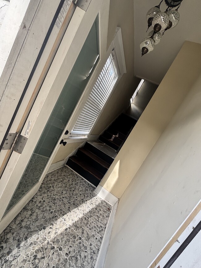 Newly tiled foyer and matching antique light. - 1108 E 32nd St