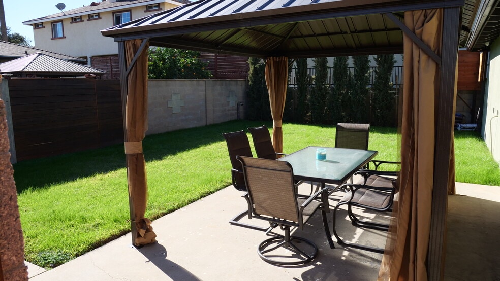 Gazebo with table and chairs for entertaining guests, bbq, or simply getting a little sun. - 259 E Puente St