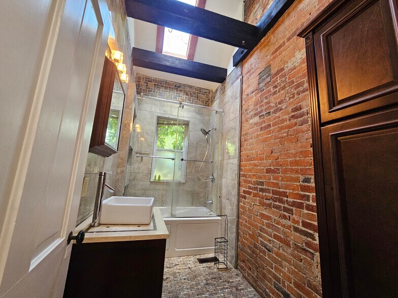 Exposed brick and a very large modern cabinet for plenty of storage - 943 Highland St