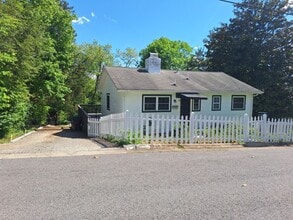Building Photo - Cute white cottage with white picket fence & Huge deck off back door!