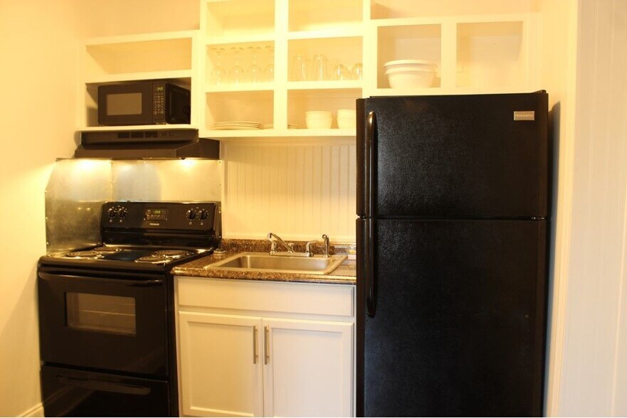 The fully stocked kitchen includes a large refrigerator with freezer. - 3813 Gallatin Pike